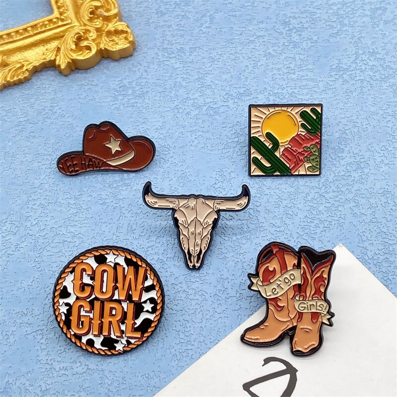 Retro-style metal lacquered brooches and badges featuring desert hats and boots from Western movies.