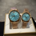 Sky blue dial with rose gold accents - left male, right female