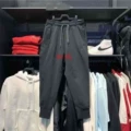 Embroidered black fleece-lined pants with lettering