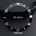 Ceramic black circle silver lettering blue green light