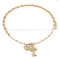 Gold smiley cross necklace