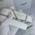 P-shaped gold buckle with white background and white belt