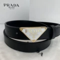 P-shaped gold buckle white background black belt