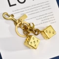 Dice string three-dimensional keychain gilt