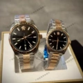 Black dial with rose gold accents - left male, right female