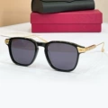 Gold and black frame, black lens