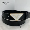 P-shaped gold buckle white background black belt