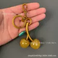 Yellow cherry pendant (with green leaves)