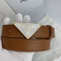 P-shaped gold buckle with white background and yellow belt