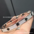 Platinum gold, wide band, black stud detail