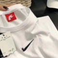 White mid-sleeve tee with a checkered pattern