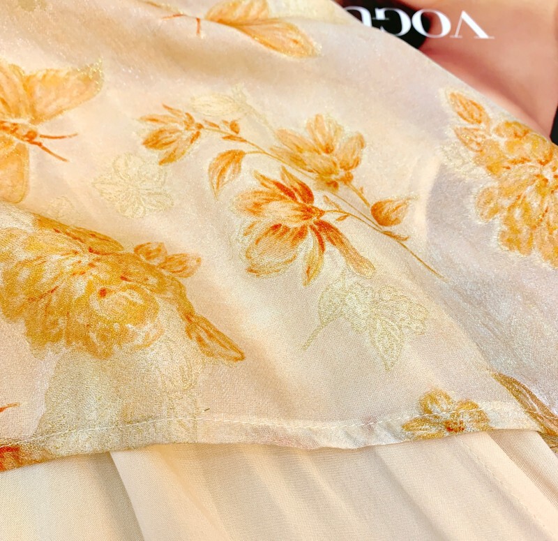 Set áo vest không tay in hoa ren cài khuy kèm chân váy xếp ly dài cạp thấp — Vàng mơ