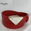 P-shaped gold buckle with white background and red belt