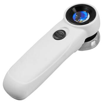 Beister holds a high-power 45x magnifying glass