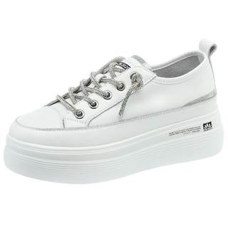 Thick-soled white shoes with rhinestone laces and platform soles