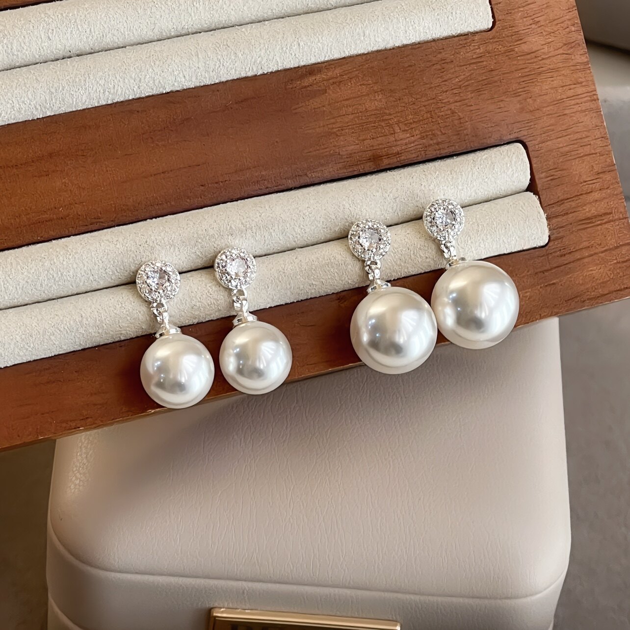 Minky "Windsor" Swarovski pearl earrings, mosquito coil ear clips, understated luxury pearl stud earrings, elegant and unique style.