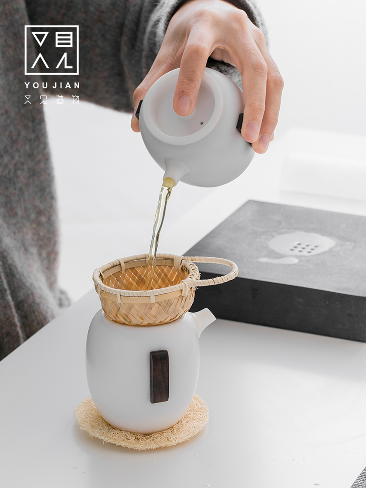 And creation of dehua white porcelain tea tea set suit household contracted hand grasp pot teapot is a complete set of tea cups