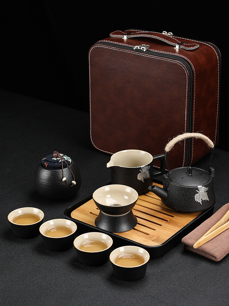 Black pottery travel kung fu tea set to crack a pot of four cups of small portable bag outside Japanese mini household contracted