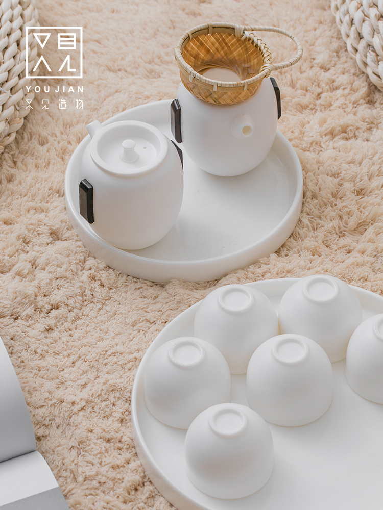 And creation of dehua white porcelain tea tea set suit household contracted hand grasp pot teapot is a complete set of tea cups