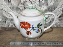 The old porcelain teapot with a hand painted flower.