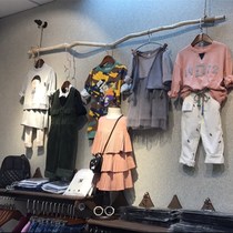 Clothing store hanger display rack vintage old solid wood branches are hanging on the wall side hanging clothing rack rack shelf