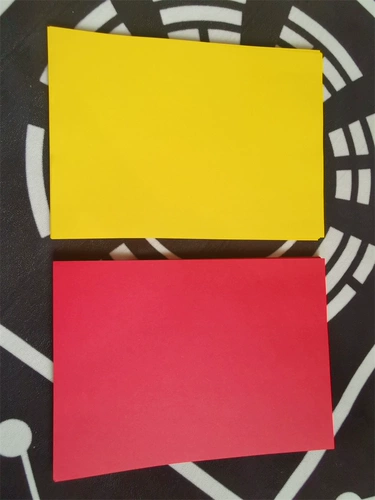 Даосский поставляет желтые часы с бумагой пустой стол и бумага на столе.