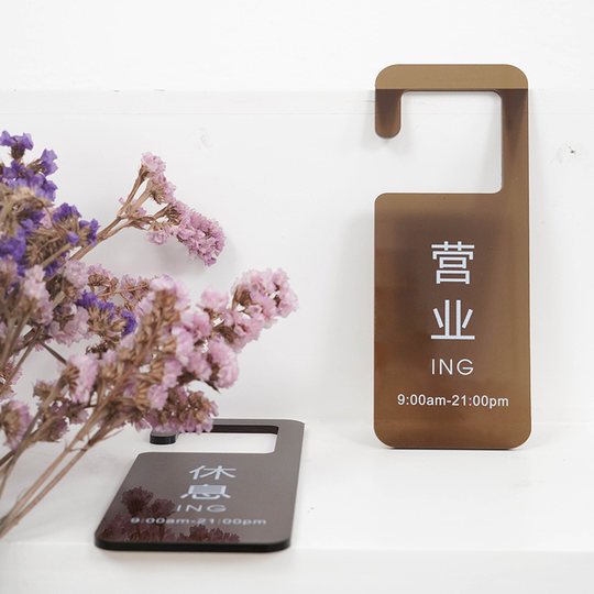 Japanese-style izakaya is open for business with a brown acrylic sign at the entrance of the restaurant that is resting and the milk tea shop is closed.