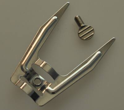 Universal accessory for electric ovens: Rotating roasting fork. The fork head for roasting chicken and duck in a household electric oven comes with fixing screws