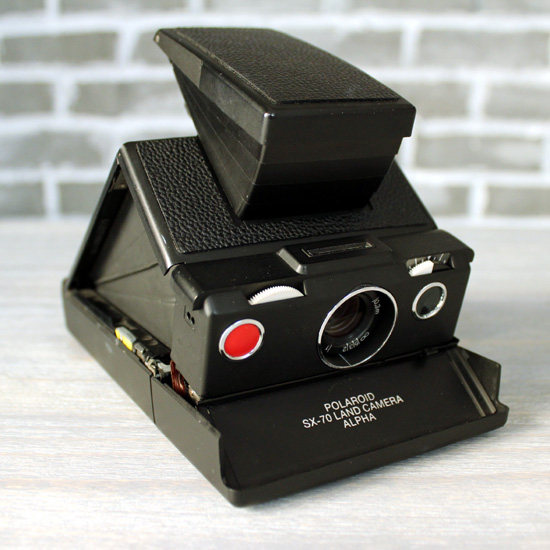 Pauli comes in SX70 black blue slapping up Alpha1 birthday gift POLAROID love letter with the same money for the camera bag