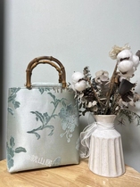Sky cyan folding branches Mudan flowers Zhangen satin large number of bamboo wrists handmade bag