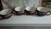 Four early coffee cups in the collection of Nestlé Coffee Souvenirs