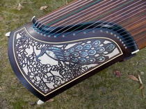 Dunhuang Guzheng 695DL specially selected Indonesian black acid branch wood Meizhuang Qin Yun shell carving Peacock pattern factory