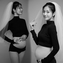 Pregnant woman photo shoot clothing new style studio simple black top solid color background modern pregnancy theme clothing