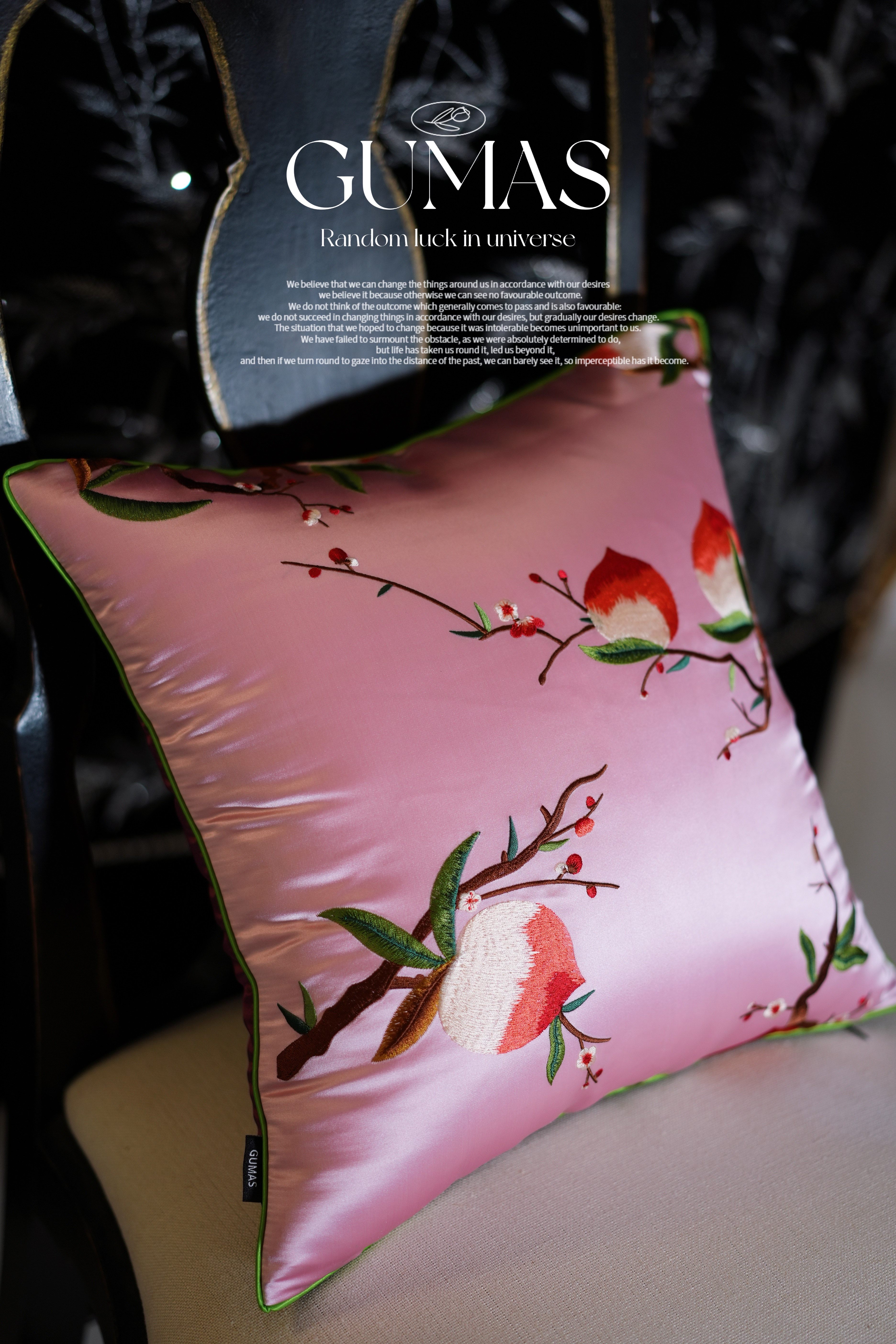 Close-up of hand-embroidered red bell-shaped flowers on silk pillow cover