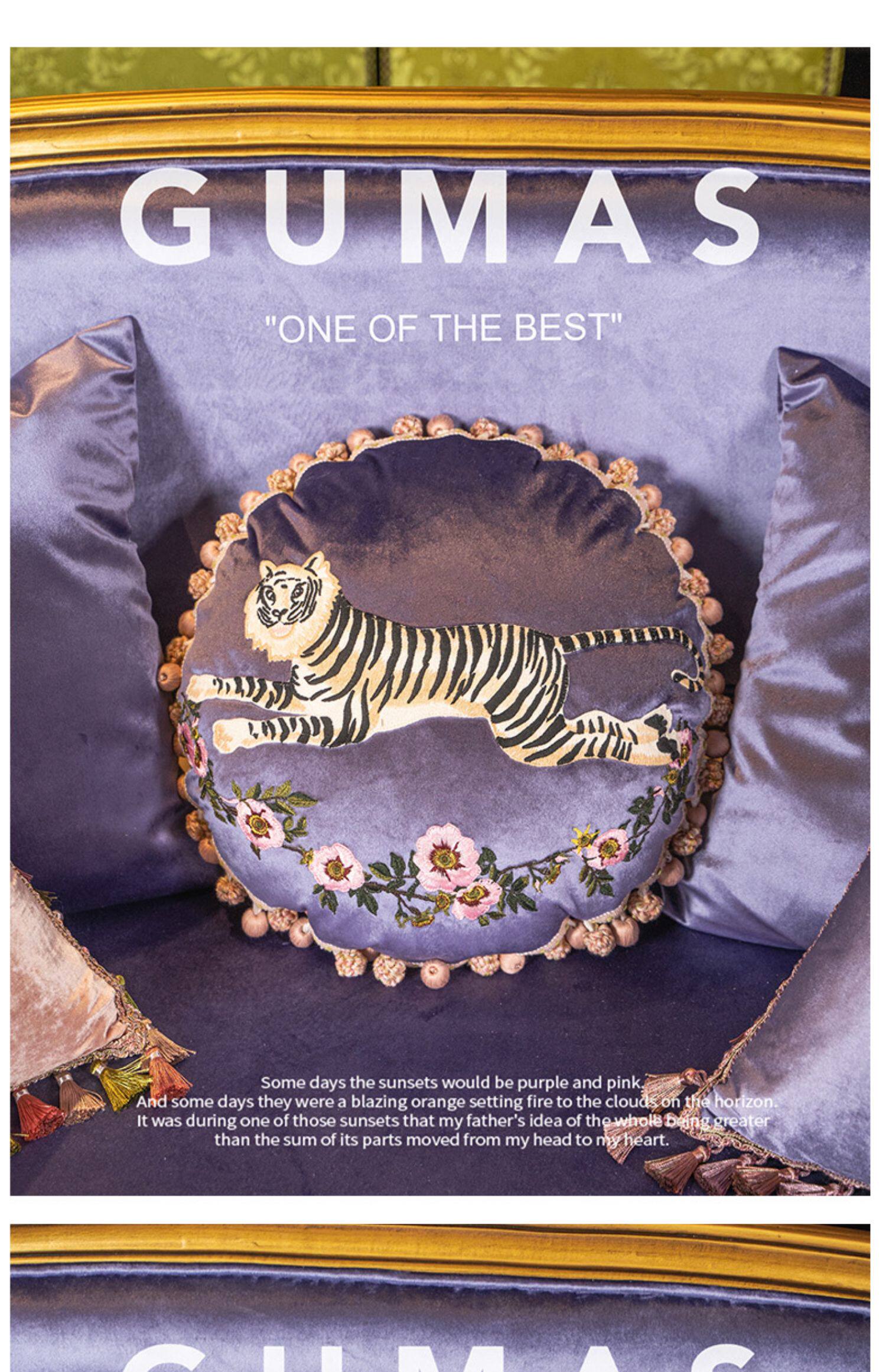 Close-up of embroidered tiger in mid-leap with gold and cream threading on purple velvet cushion