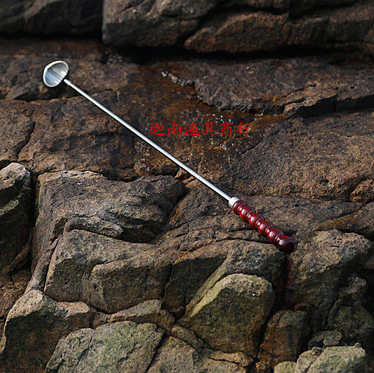 Advanced carbon rod wood handle with bait spoons far head spoons tossed and spoonful of bait