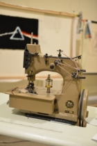 Tufting carpet lock edge machine