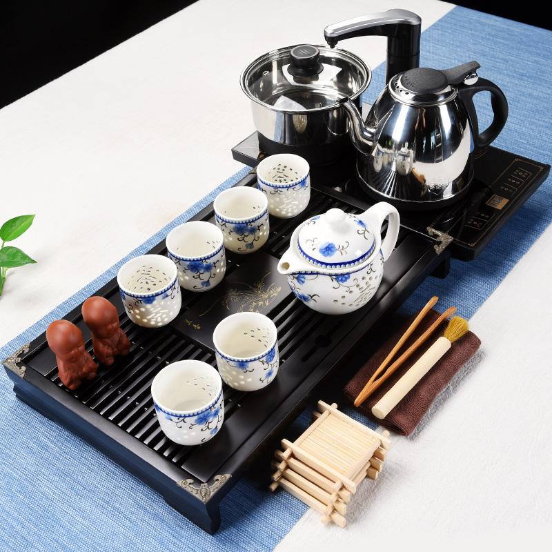 The cabinet of a complete set of ceramic tea set household contracted and I kung fu tea tray was four unity electrothermal furnace tea cups