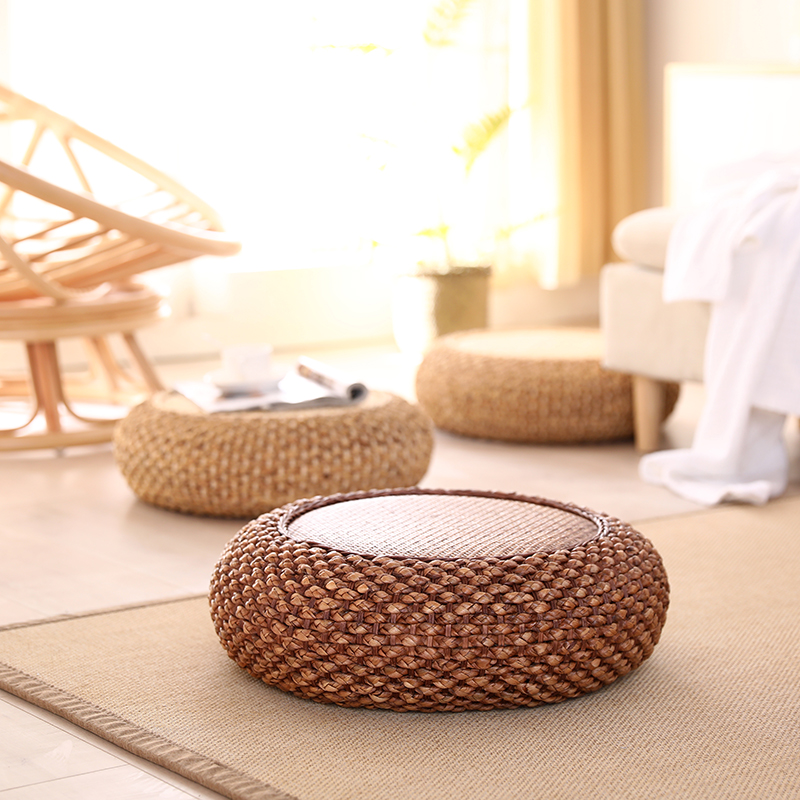 Rattan-choreographer sits on a bench tatami cushion thickened Japanese style and sit down for a beaver Zen meditation room for a sitting mound
