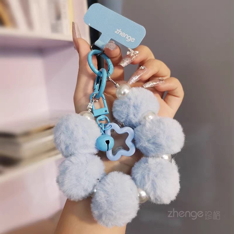 Short mobile phone lanyard with pom-pom and pearl design, perfect for autumn and winter. High-end plush, anti-loss, and sturdy chain case.