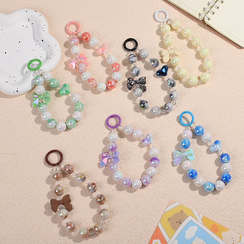 New DIY mobile phone case pendant short mobile phone chain bow two-color beaded earphone bag pendant pendant