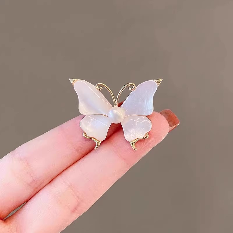 Outlet brand discount store closing sale: find mother-of-pearl pearl butterfly brooches at outlet women's accessories.