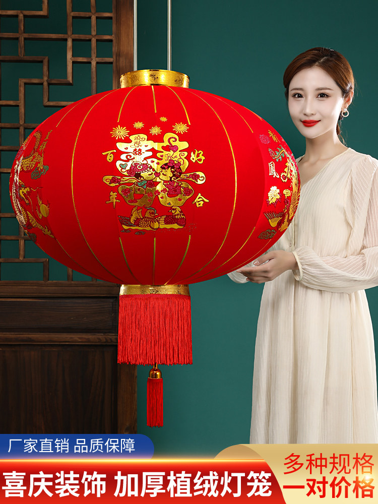 A pair of festive outdoor waterproof chandelier decorations on the balcony with a pair of red lanterns for wedding celebration and wedding ceremony