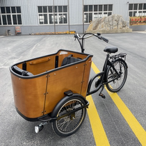 Riding a pedal tricycle backwards a light human-powered bicycle to transport children to and from school a stroller