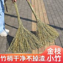 A whole bunch of golden branches and small bamboo brooms outdoor courtyard road garden property cleaning tools manufacturer