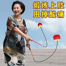 Middle-aged and elderly people swing the ball fitness ball bouncy ball jump ball fall ball tennis exercise with rope for soreness