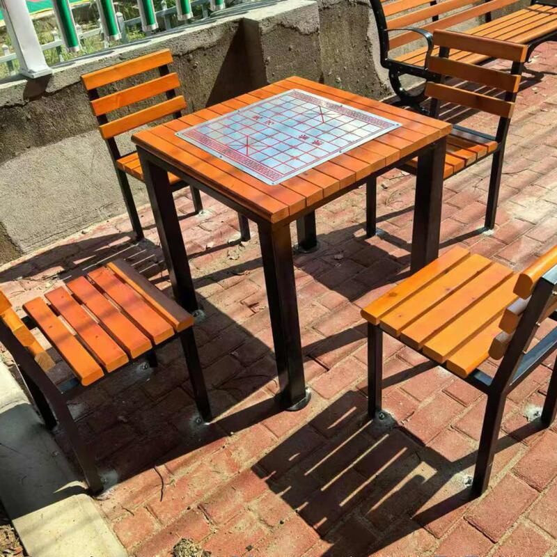 A Set of Outdoor Chess and Card Tables and Chairs with Backrests for the Community, Including a Table with Four Chairs and a Chinese Chess Board
