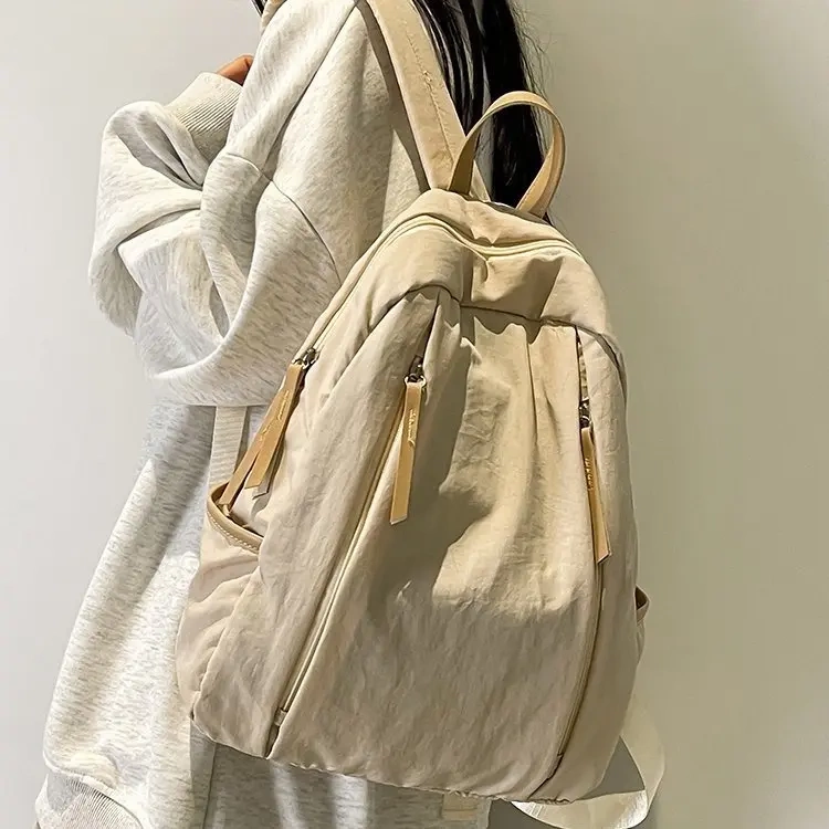 The Rose-Colored Iac Korean-Style Large-Capacity Nylon Student Backpack in Mom's Hand Is a Casual and Versatile Double-Shoulder Backpack
