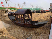 Nostalgic old-fashioned black boat with Pompet boat old wooden cruise old fishing boat old Oar folk display old objects