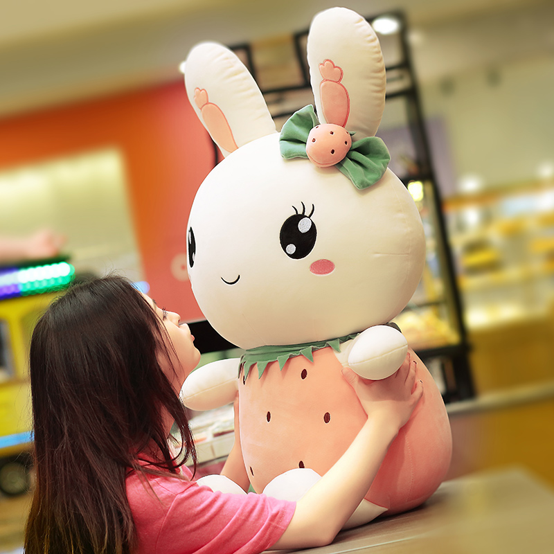 Cute plush toy rabbit doll girl sleeping in a dude bed with birthday present little white rabbit